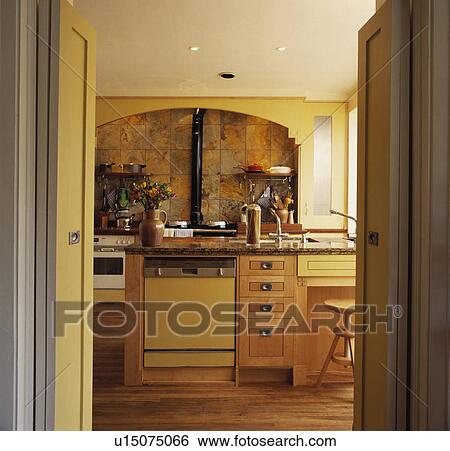 Stock Images Of Open Doorway To Pastel Yellow Kitchen With Open Doorway To Pastel Yellow Kitchen With Dishwasher In Island Unit