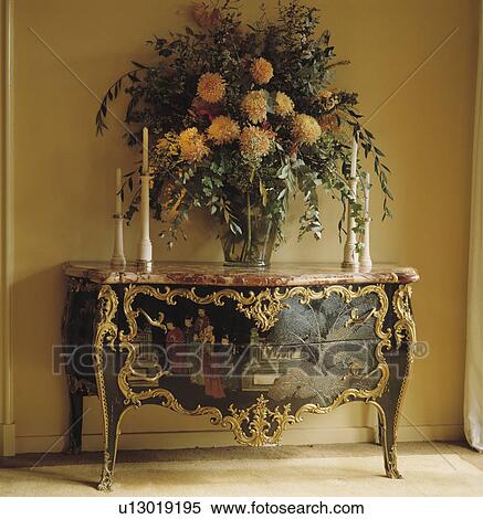 Orange chrysanthemums in large floral arrangement on antique Chinese console table with gilt edging View Large Photo Image Stock Photography - Orange chrysanthemums in large floral arrangement on antique Chinese console table with gilt edging. Fotosearch