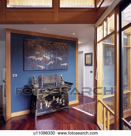 Oriental picture above inlaid Chinese lacquered table in modern hall with blue wall and wooden flooring View Large Photo Image Stock Image - Oriental picture above inlaid Chinese lacquered table in modern hall with blue wall and wooden flooring. Fotosearch