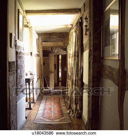 Oriental rug and long curtains on beamed country landing View Large Photo Image Stock Photograph - Oriental rug and long curtains on beamed country landing. Fotosearch