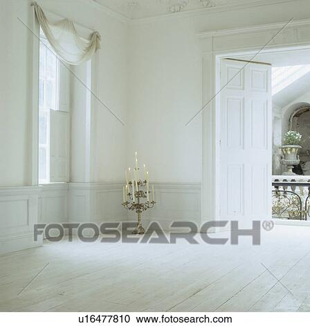 Ornate candlestick in empty white Georgian hall with white wooden floor and dado panelling View Large Photo Image Stock Image - Ornate candlestick in empty white Georgian hall with white wooden floor and dado panelling . Fotosearch