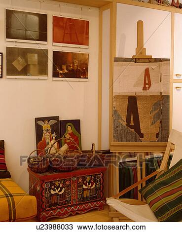 Stock Image - Painted chest and easel in artist's studio. Fotosearch
