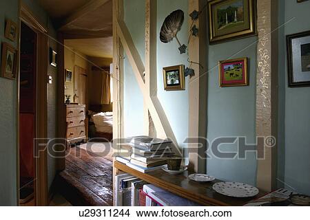Picture - Painted wall beams in pastel blue cottage hall with door open to living room. Fotosearch