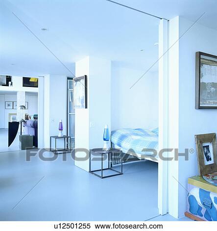 Pale blue flooring in modern openplan apartment with sliding doors between rooms View Large Photo Image Stock Photography - Pale blue flooring in modern openplan apartment with sliding doors between rooms. Fotosearch