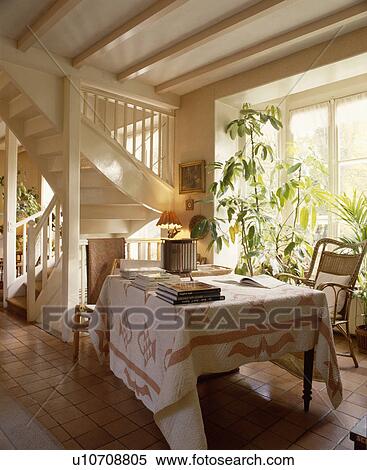 Patchwork cloth on table beside staircase in traditional living room View Large Photo Image Stock Photography - Patchwork cloth on table beside staircase in traditional living room. Fotosearch