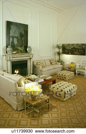 Patterned carpet and cream sofas in traditional living room with picture above fireplace View Large Photo Image Stock Image - Patterned carpet and cream sofas in traditional living room with picture above fireplace. Fotosearch