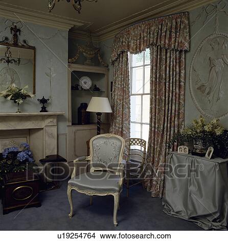 Patterned curtains in traditional living room with trompe l'oeil murals View Large Photo Image Picture - Patterned curtains in traditional living room with trompe l'oeil murals. Fotosearch