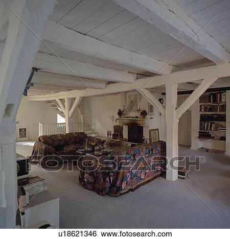 Patterned Sofas In Eighties Living Room With White Painted Beamed