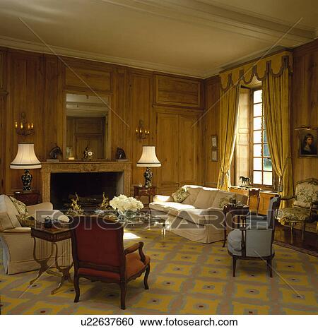 Stock Image - patterned yellow carpet in traditional patterned country living room. Fotosearch