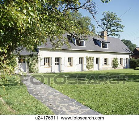 Paved path and lawn in front of traditional single-storey country house in France View Large Photo Image Stock Image - Paved path and lawn in front of traditional single-storey country house in France. Fotosearch