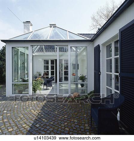 Stock Photo - Paving setts in front of conservatory extension on modern white house. Fotosearch