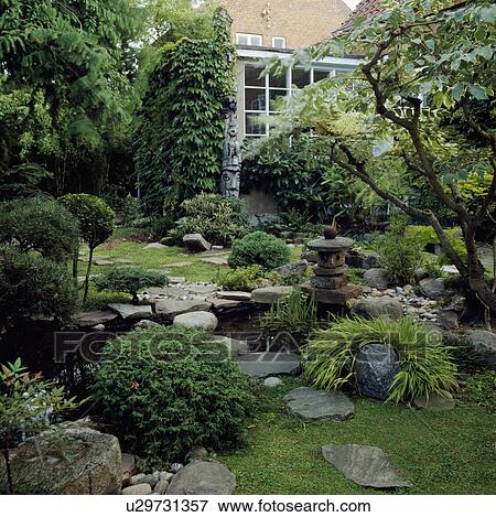 Paving stones and small natural pond garden in summer View Large Photo Image Stock Photo - Paving stones and small natural pond garden in summer. Fotosearch