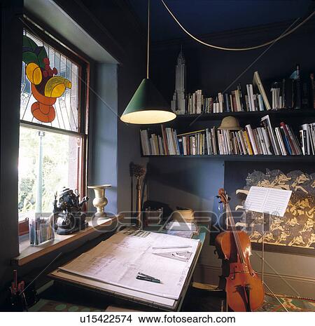 Picture - Pendant light above drawing-board in small blue study. Fotosearch