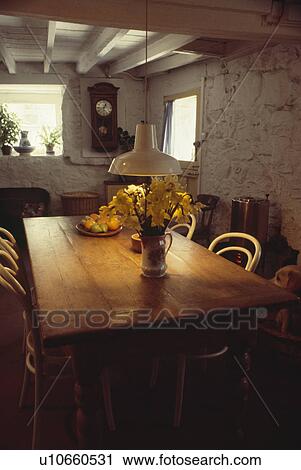 Pendant light over pine table in cottage dining room View Large Photo Image Stock Image - Pendant light over pine table in cottage dining room. Fotosearch