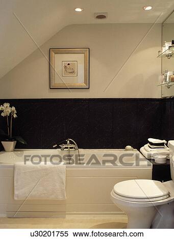Stock Photography - Picture above bath in modern black and white attic bathroom. Fotosearch