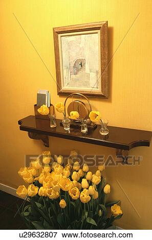 Picture and small wooden shelf above yellow tulips in yellow hall View Large Photo Image Stock Photo - Picture and small wooden shelf above yellow tulips in yellow hall. Fotosearch