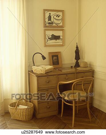 Stock Photo - Pictures above pine desk with Bentwood chair. Fotosearch