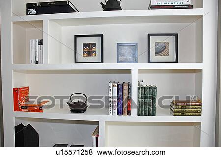 Pictures and books on modern white shelves View Large Photo Image Stock Photo - Pictures and books on modern white shelves. Fotosearch