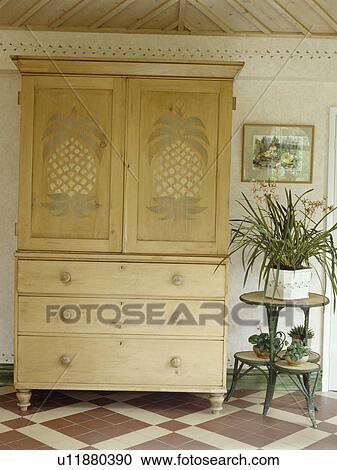 Stock Image - Pine linen press with stencilled detail. Fotosearch