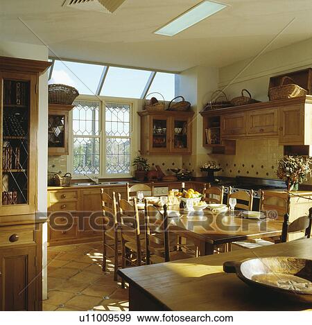 Stock Photo - Pine table and chairs in neutral kitchen and dining room extension. Fotosearch