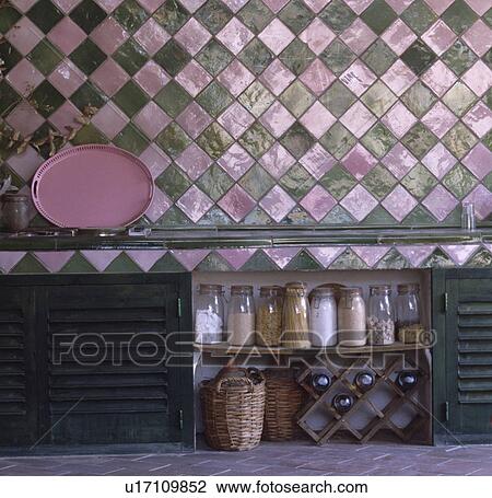 Pink+green diamond-shaped tiles above glass storage jars on rustic wooden shelving View Large Photo Image Stock Image - Pink+green diamond-shaped tiles above glass storage jars on rustic wooden shelving. Fotosearch
