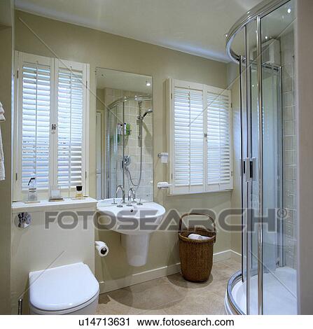 Plantation Shutters In Modern White Bathroom With Glass