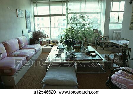 Plants on table with built-in seating in modern apartment living room View Large Photo Image Stock Image - Plants on table with built-in seating in modern apartment living room. Fotosearch