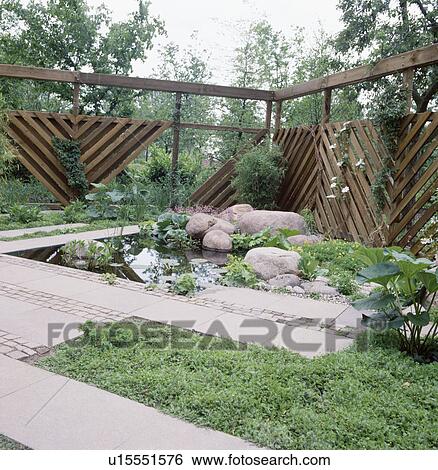 Stock Photograph -  Pond and paving in town garden. Fotosearch