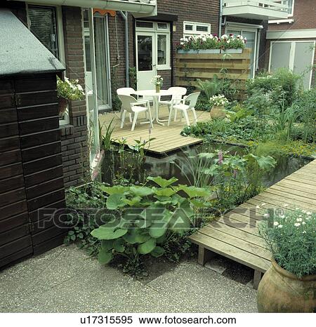 Pond with decking and water plants in town garden View Large Photo Image Stock Photography - Pond with decking and water plants in town garden. Fotosearch