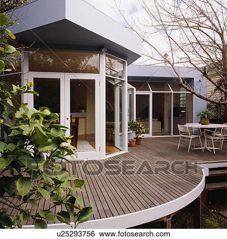 Raised and curved decked area outside the rear of an architectural home View Large Photo Image Stock Photograph - Raised and curved decked area outside the rear of an architectural home. Fotosearch