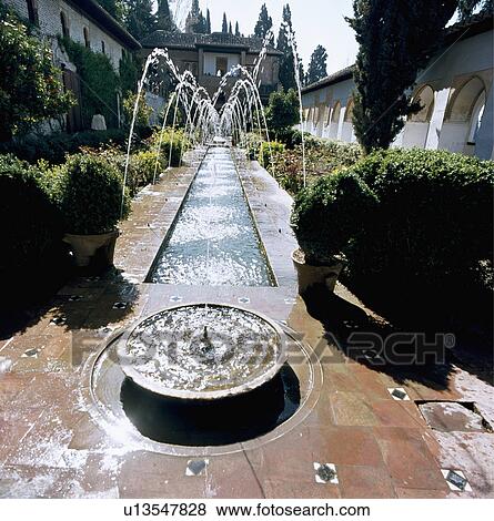 Stock Photo - Raised circular pool and fountains along rectangular pool in Alhambra garden. Fotosearch
