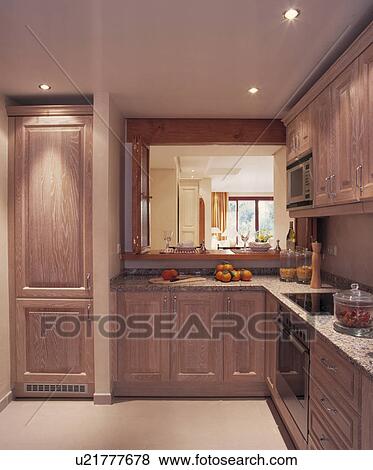 Recessed Halogen Ceiling Lights In Modern Wood Fitted Kitchen