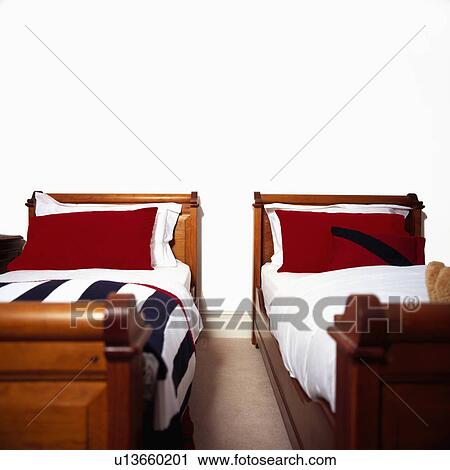 Red pillows and white linen on traditional twin beds in modern white bedroom View Large Photo Image Stock Image - Red pillows and white linen on traditional twin beds in modern white bedroom. Fotosearch