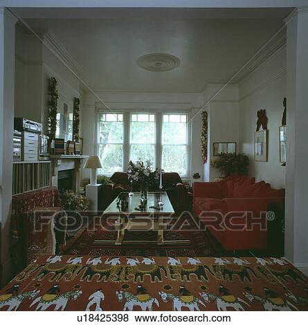 Red sofa and kelim rug in traditional living room View Large Photo Image Stock Photo - Red sofa and kelim rug in traditional living room. Fotosearch