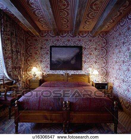 Red White Indian Cotton Fabric On Walls And Ceiling Of Bedroom With Picture Above Bed Stock Photo