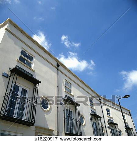 Regency-style terraced houses with wrought-iron balconies and canopies on 1st-floor windows viewed from below View Large Photo Image Stock Photo - Regency-style terraced houses with wrought-iron balconies and canopies on 1st-floor windows viewed from below. Fotosearch