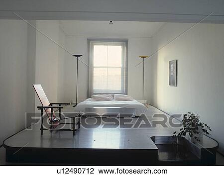 Rietveld chair on raised polished platform with white bed and tall floor lamps in modern white minimalist bedroom View Large Photo Image Stock Image - Rietveld chair on raised polished platform with white bed and tall floor lamps in modern white minimalist bedroom. Fotosearch