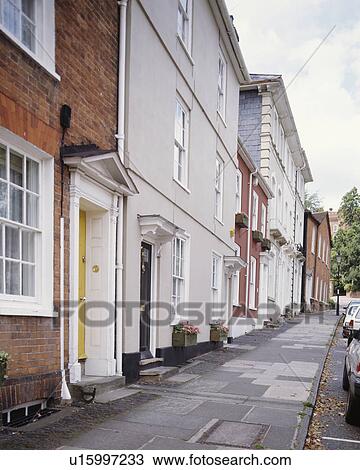 Stock Image - Row of terraced Georgian and Victorian townhouses beside the pavement. Fotosearch