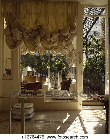 Stock Photograph - Ruched blind in living room. Fotosearch