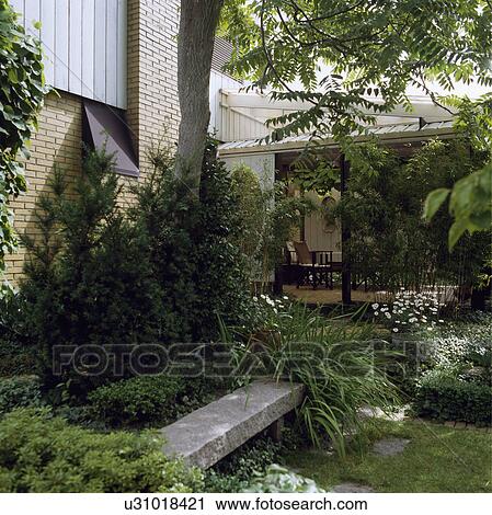Rustic stone bench in green town garden in summer View Large Photo Image Stock Image - Rustic stone bench in green town garden in summer. Fotosearch