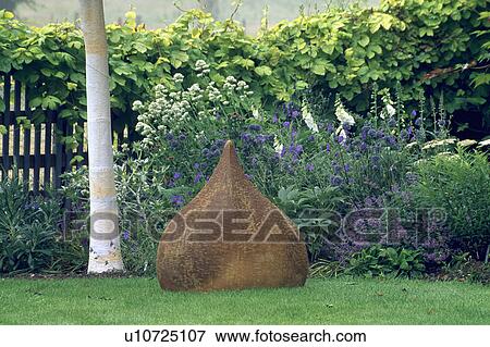 Sculpture in flowering borders in country garden in summer View Large Photo Image Stock Photo - Sculpture in flowering borders in country garden in summer. Fotosearch