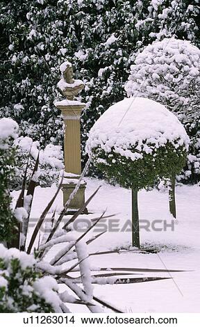 Picture - Sculpture in snow in country garden in winter. Fotosearch