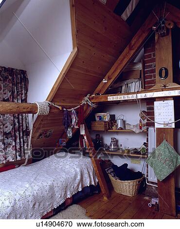 Shelving below panelled ceiling in child's attic bedroom View Large Photo Image Stock Image - Shelving below panelled ceiling in child's attic bedroom. Fotosearch