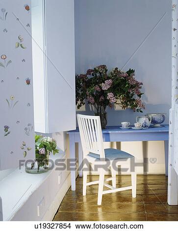 Shutters on window in pastel blue room with white chair and pale blue table View Large Photo Image Picture - Shutters on window in pastel blue room with white chair and pale blue table . Fotosearch