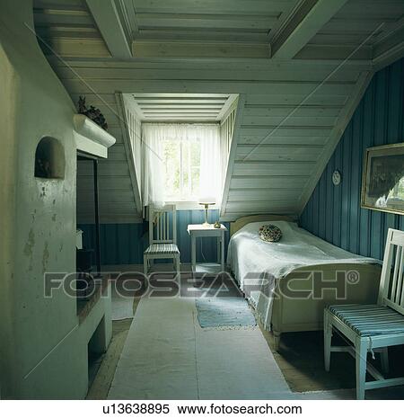 Single wooden bed with white bedcover in wood panelled Scandinavian attic bedroom with white rug View Large Photo Image Stock Photography - Single wooden bed with white bedcover in wood panelled Scandinavian attic bedroom with white rug. Fotosearch