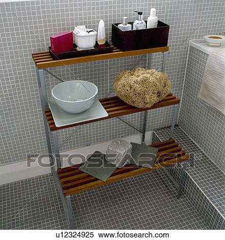Slatted wood and metal shelf unit with large sponge and box of toiletries in modern bathroom View Large Photo Image Stock Photography - Slatted wood and metal shelf unit with large sponge and box of toiletries in modern bathroom. Fotosearch