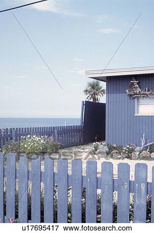 Stock Photo - Small blue fenced seaside garden on East Coast of USA. Fotosearch