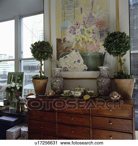 Small clipped trees on chest-of-drawers below picture View Large Photo Image Stock Image - Small clipped trees on chest-of-drawers below picture. Fotosearch