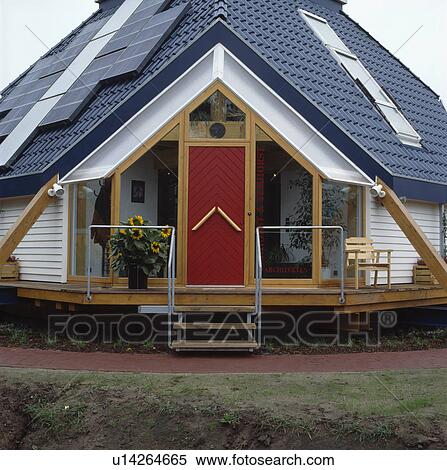 Solar panels on roof of raised modern house with red front door View Large Photo Image Stock Photography - Solar panels on roof of raised modern house with red front door. Fotosearch