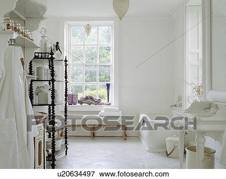 Spacious white country bathroom with antique barleytwist shelving and white tiled floor View Large Photo Image Stock Photo - Spacious white country bathroom with antique barleytwist shelving and white tiled floor. Fotosearch